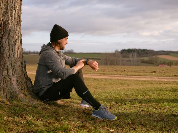 Runner taking a break from exercise to check notification on apple smartwatch