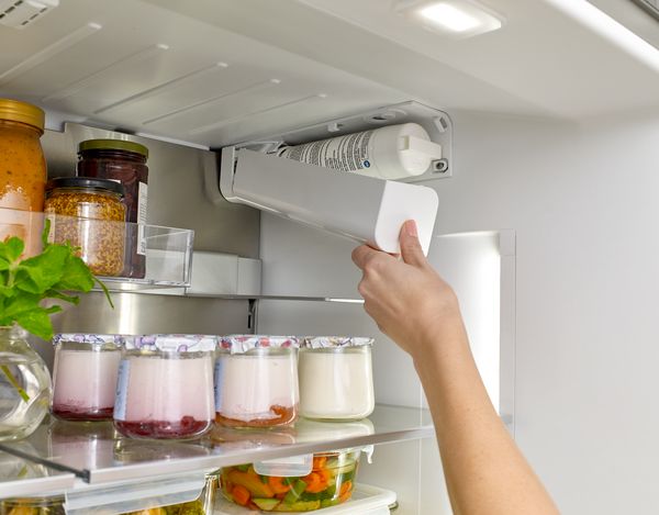 Water filter being added to fridge